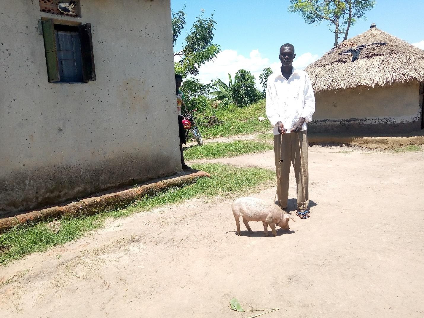 Moses Okello with his piglet