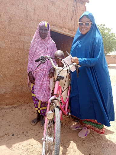 Sahura Munkaila with grandson and bike