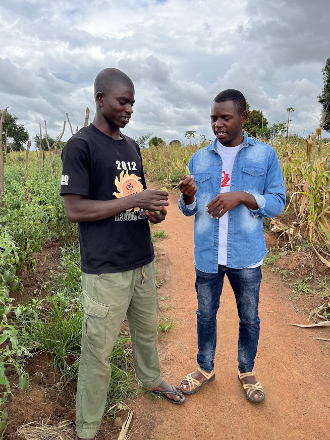 young farmer Tyson Thobias and technical field officer Mganga Togolai