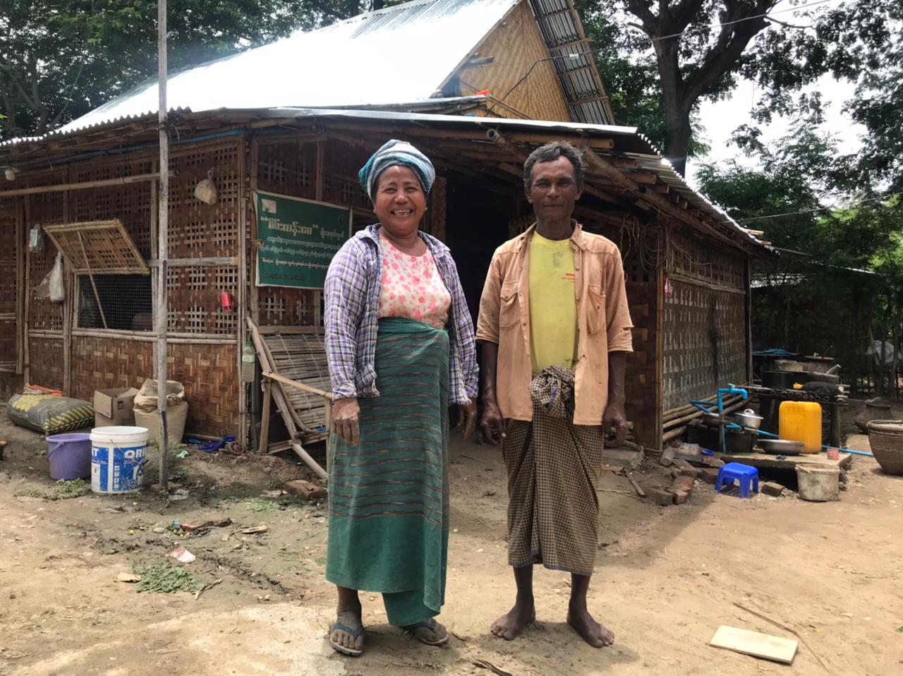 Key farmer couple in front of their house in Myanmar