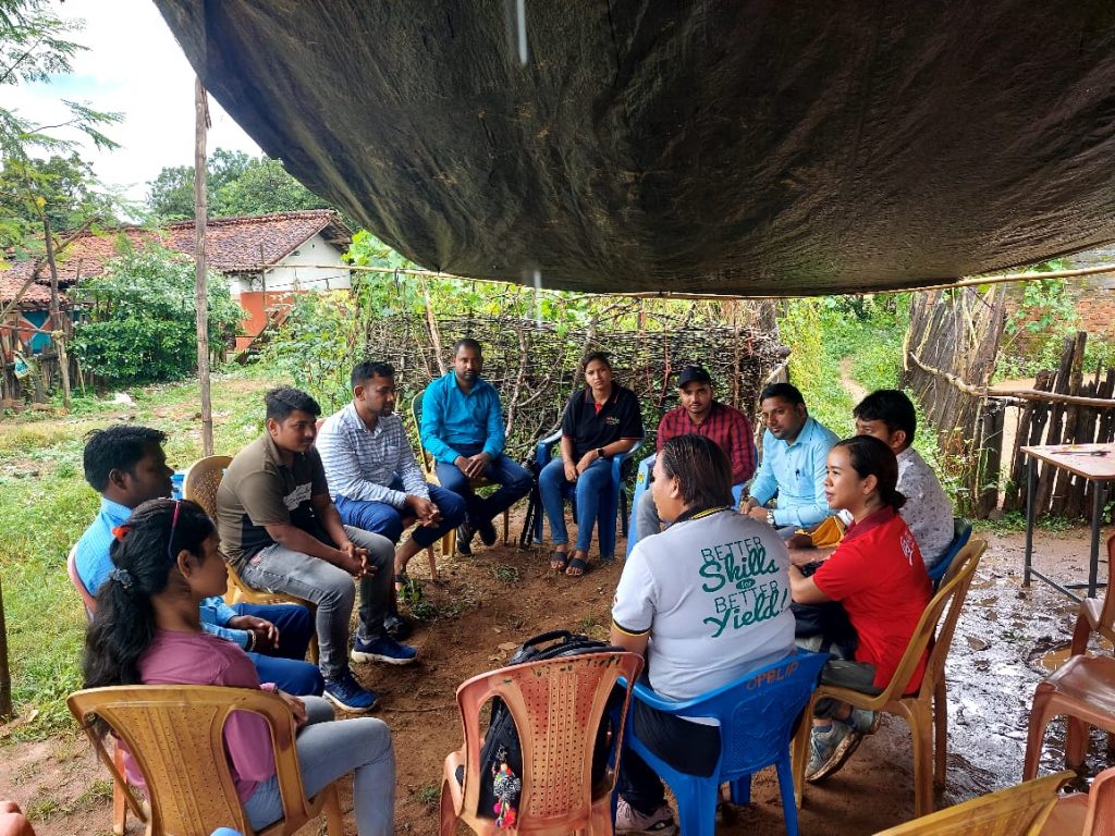 EWS-KT Odisha team meeting under a rain shelter