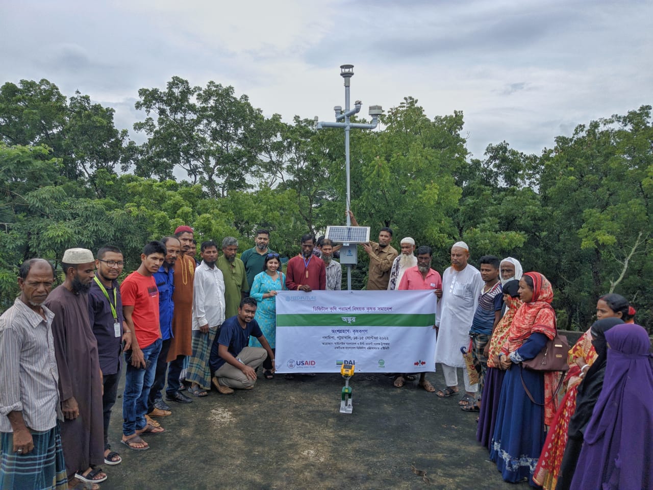 people gather for weather station installation in Bangladesh
