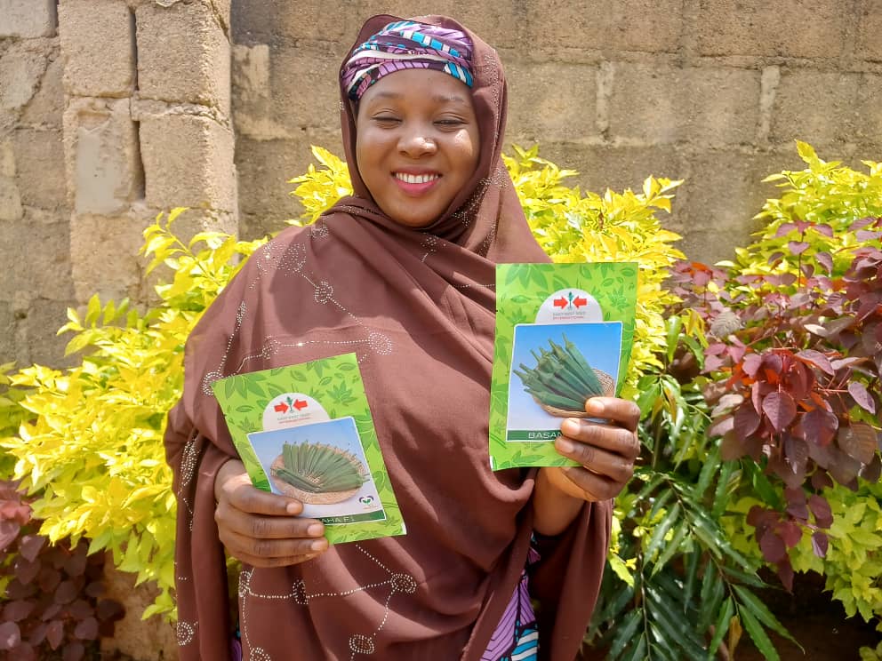 Farmer Aisha Yusuf with okra seed packets from East-West Seed