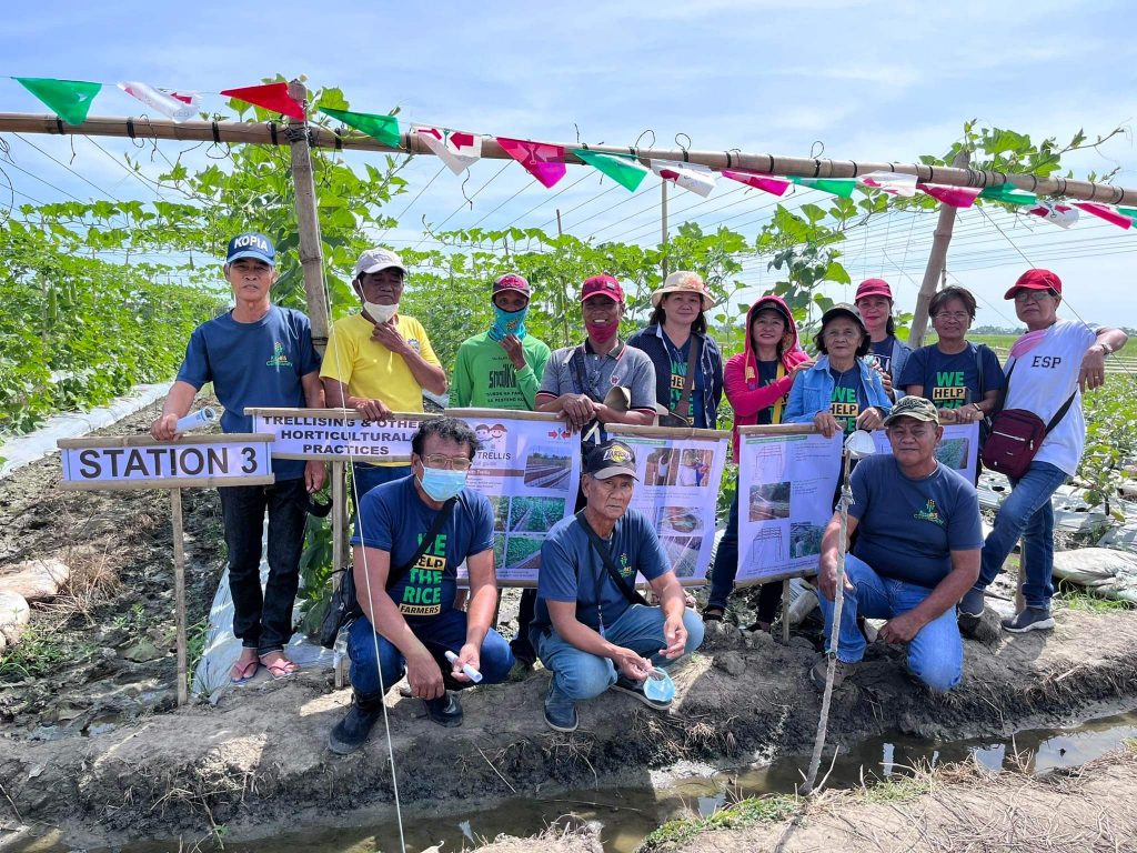Staff pose at Station 3, which educates farmers about trellising.