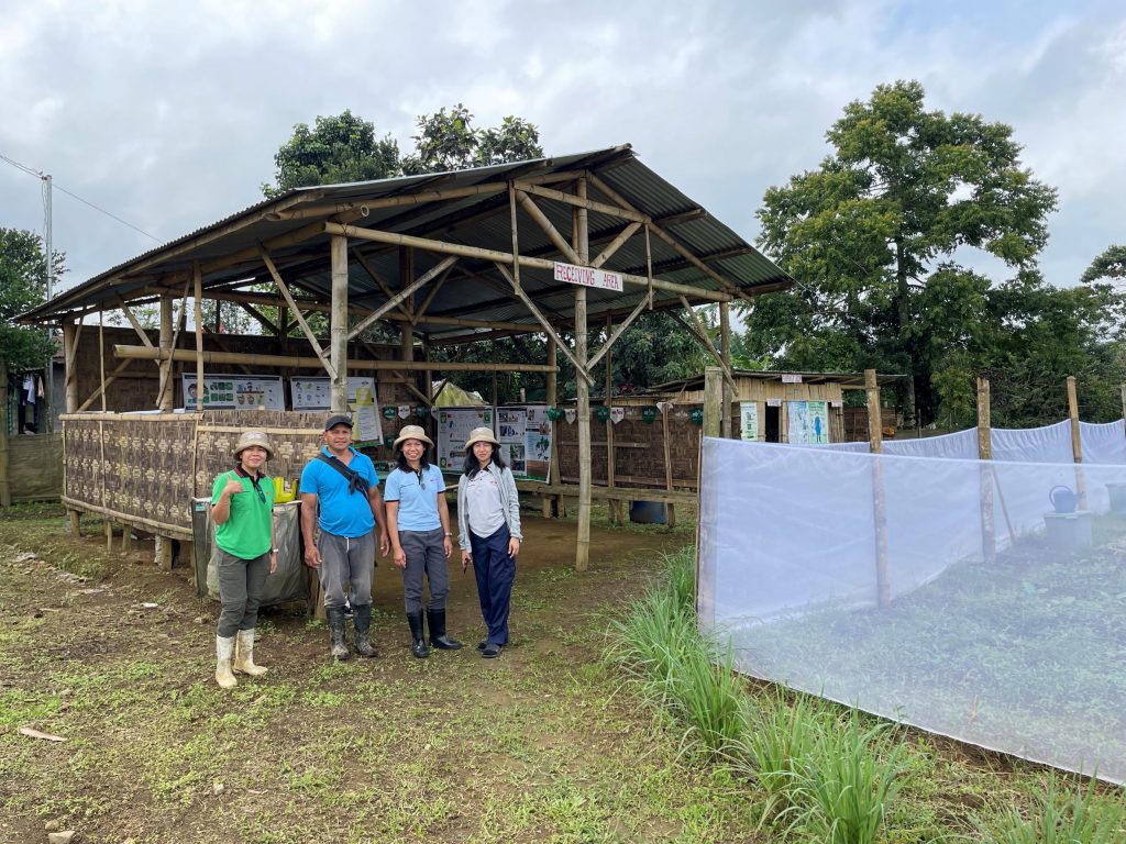 The learning farm team stands in front of the training building