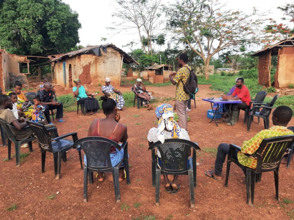 Simon Ossom talking with a farmer savings and loan group in Ghana