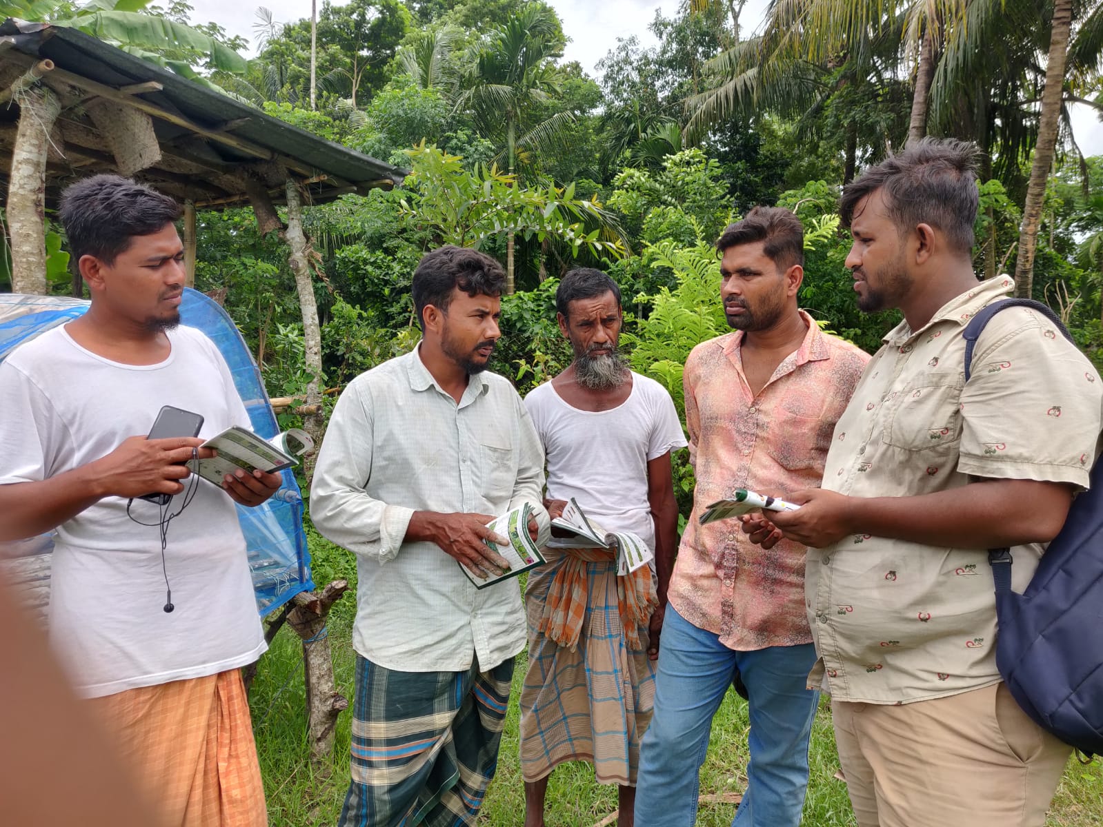 discussing crop guide with farmers
