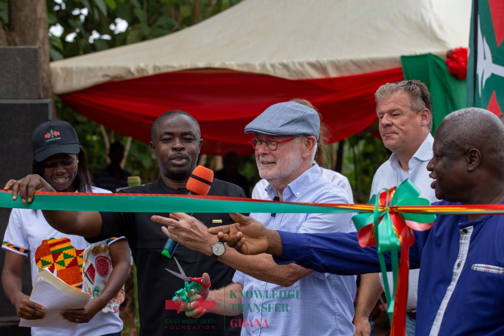 H.E. Jeroen Verheul, Ambassador of the Netherlands Embassy to Ghana prepares to cut the ceremonial ribbon to open the learning farm as Jemima Djah, EWS-KT Knowledge Transfer Manager for Ghana; Ansu Kumi, Municipal Chief Executive for the Sunyani Municipal Assembly; Coen Everts, East-West Seed Regional Business Head, West Africa; and Dennis Abugri Amenga, Regional Director of Agriculture, Bono Region, look on.