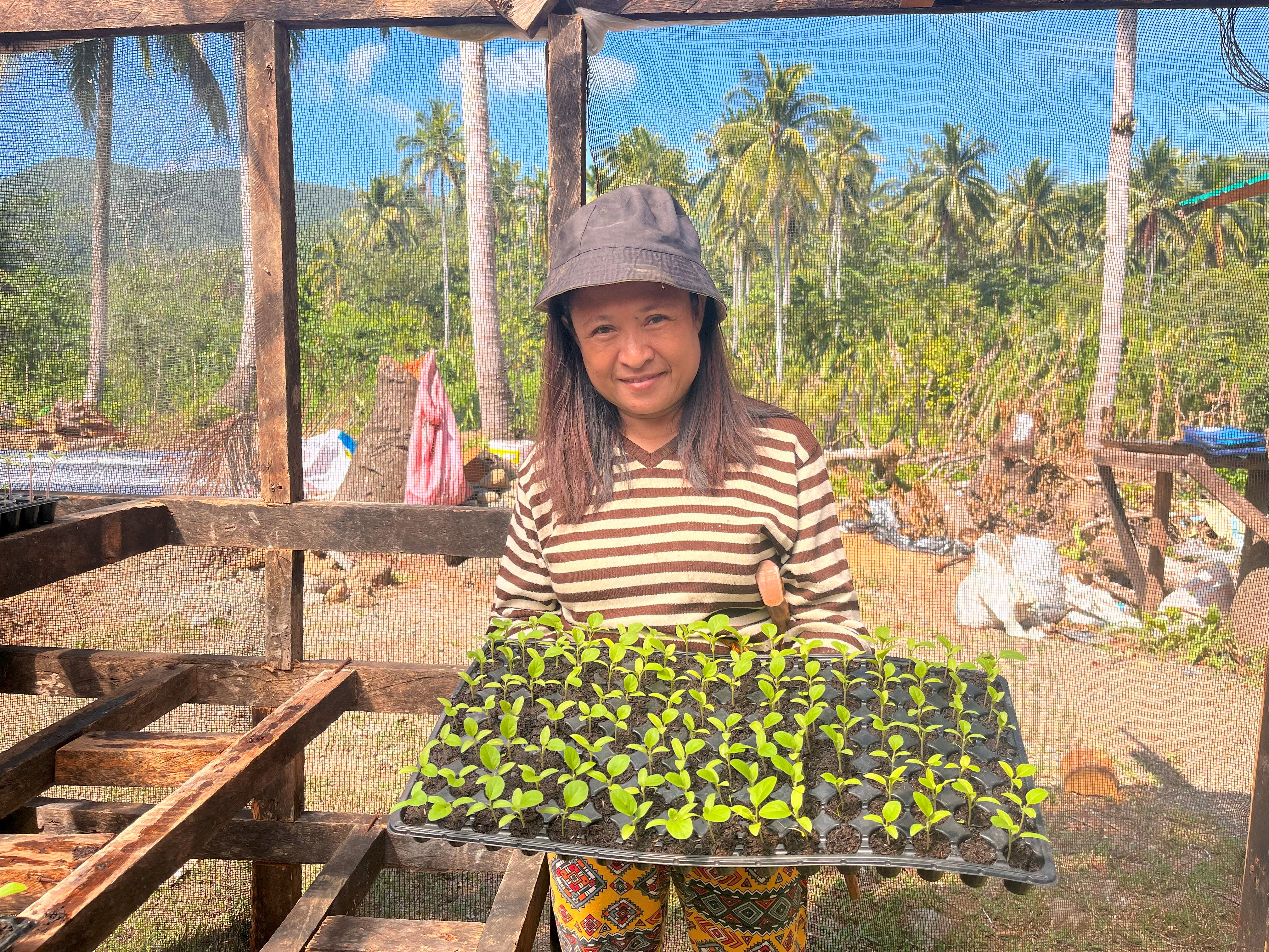 Woman farmers with tray of seedlings