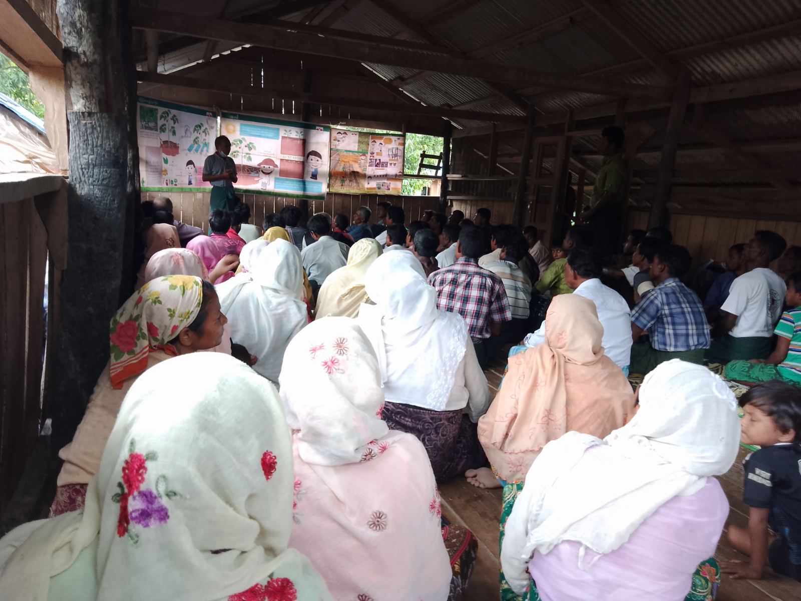 Holding a classroom training for a large group of farmers