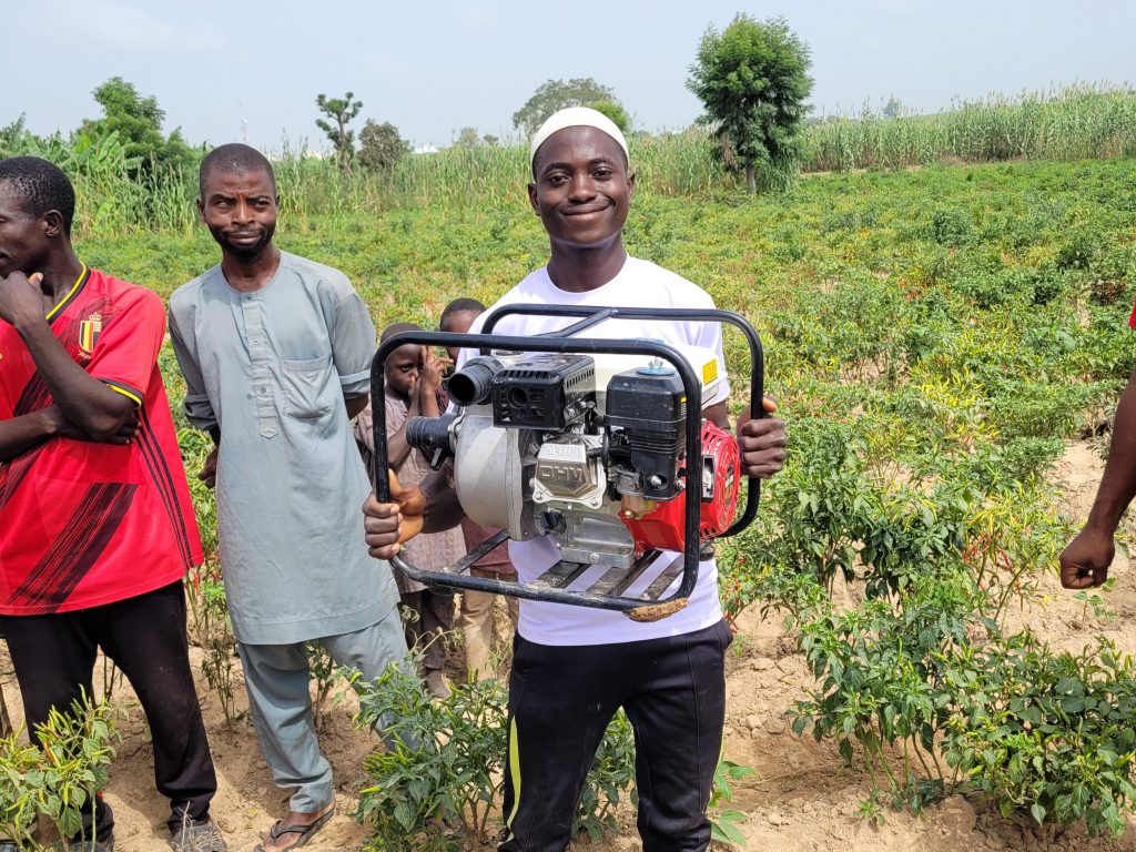 Farmer Abubakar Magaji proudly holds his new water pump.