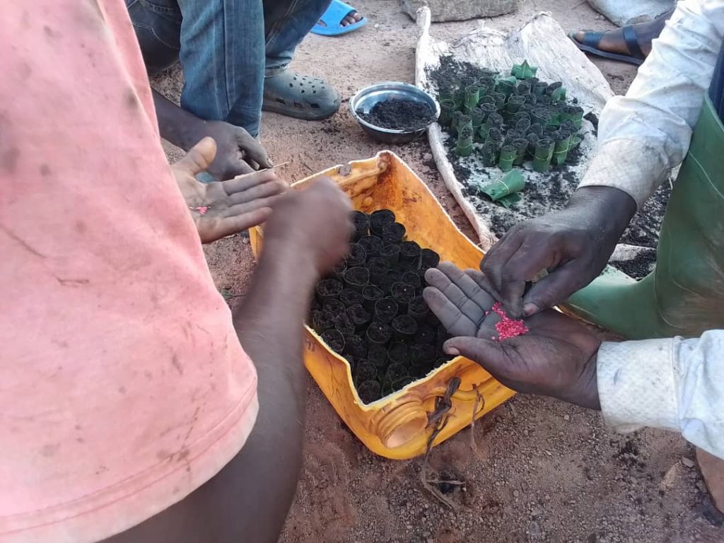 Farmers practice making seedling pots.