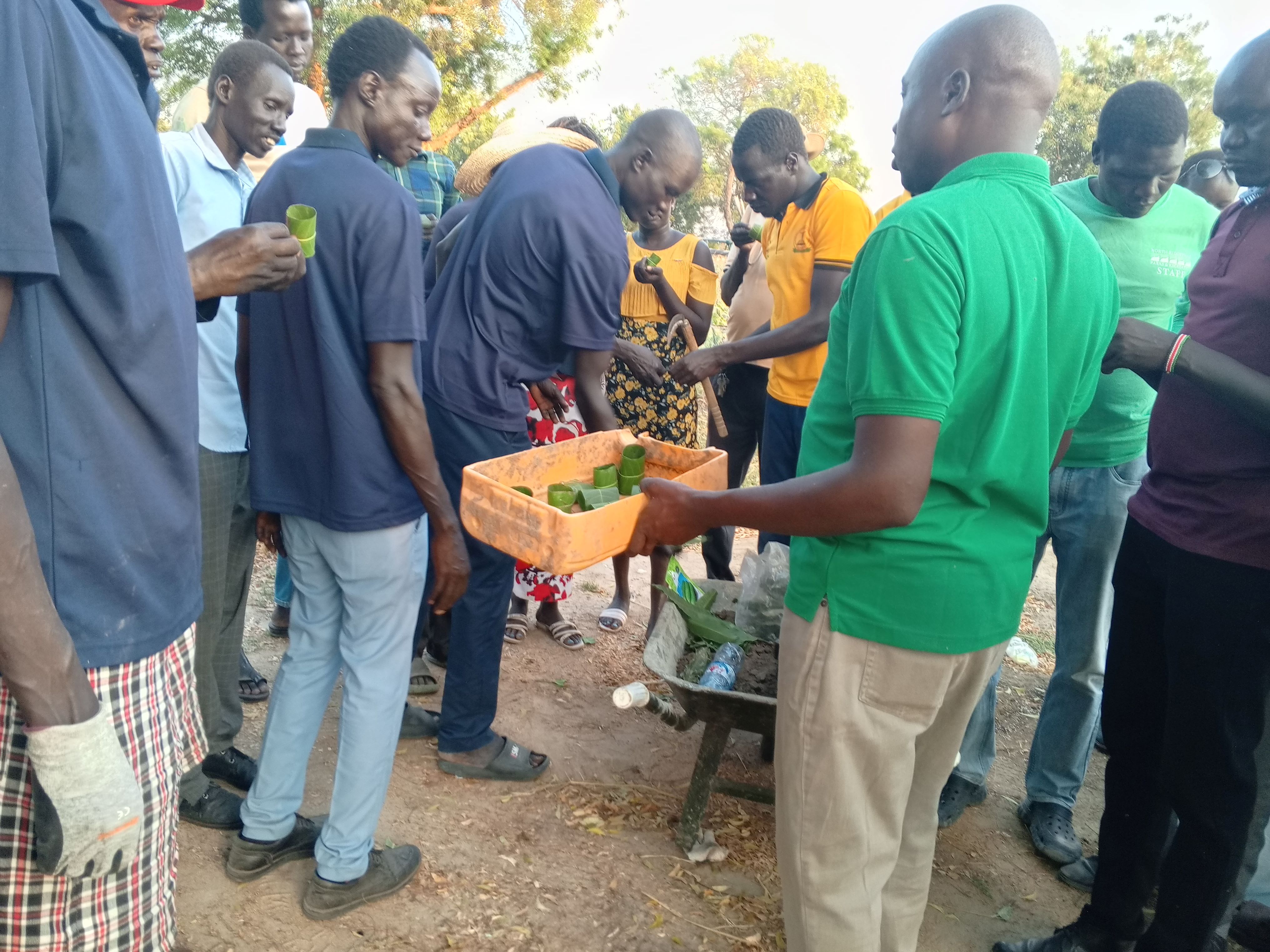Agricultural extension specialists practice making leaf pots for seedlings during a training of trainers in Bor, South Sudan.