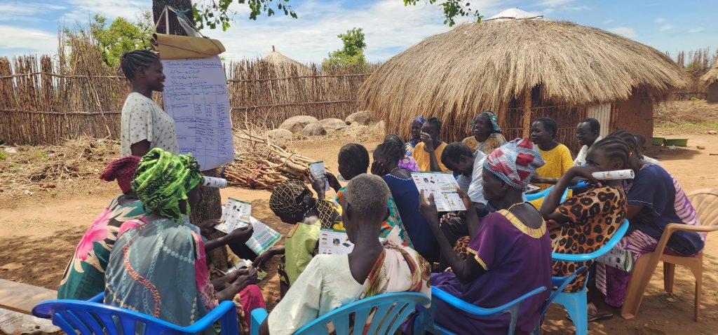 Farmer Angelina Hassan explains her business plan to a group of other farmers.