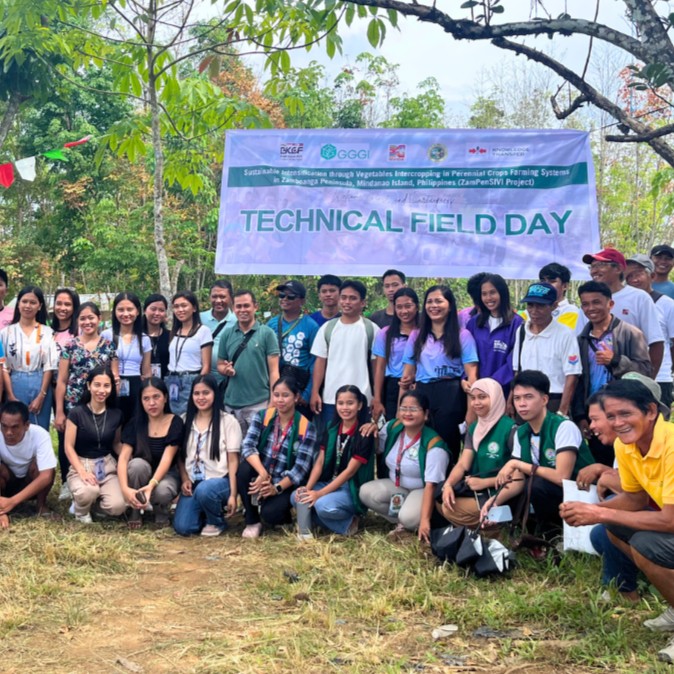 Technical Field Day attendees in Zamboanga Sibugay stand beneath a Technical Field Day banner.