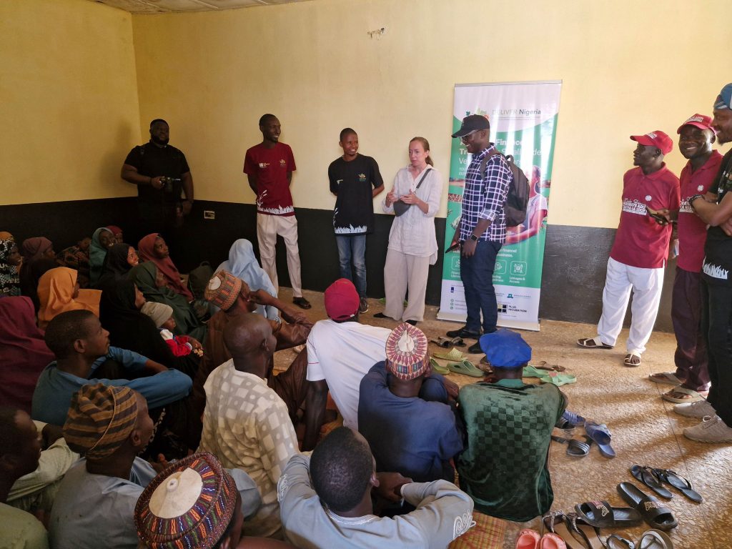 RVO Senior Project Advisor Eline Minneboo, with DELIVER Nigeria Project Coordinator Martin Tajan Musa of GAIN, talking with participants of the access-to-finance awareness campaign.