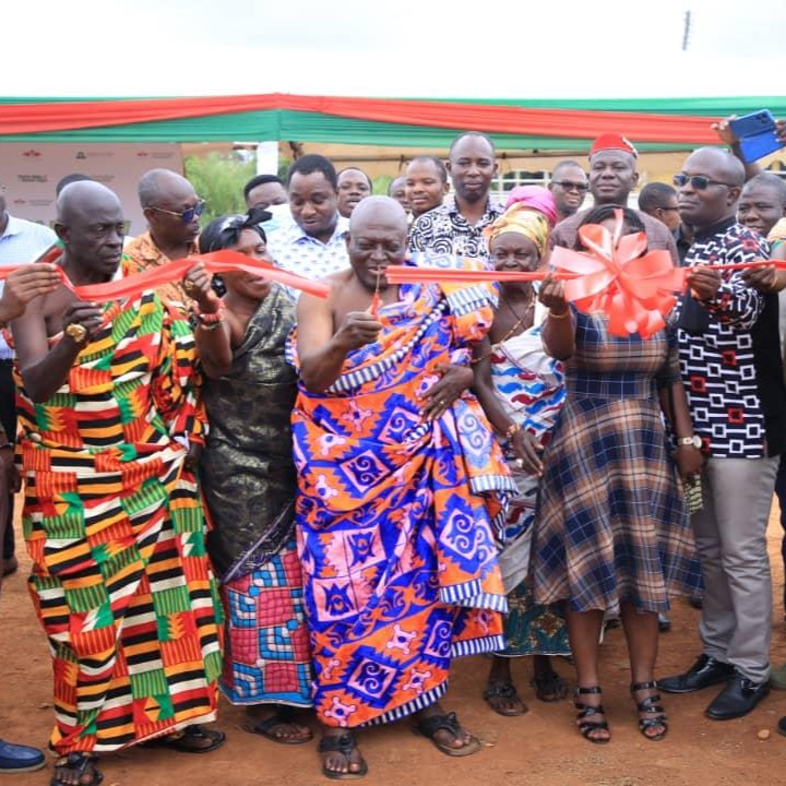 Standing with a large group of visitors, Nana Bonsu, chief of Duayaw Nkwanta, cuts the ribbon to open the learning farm.