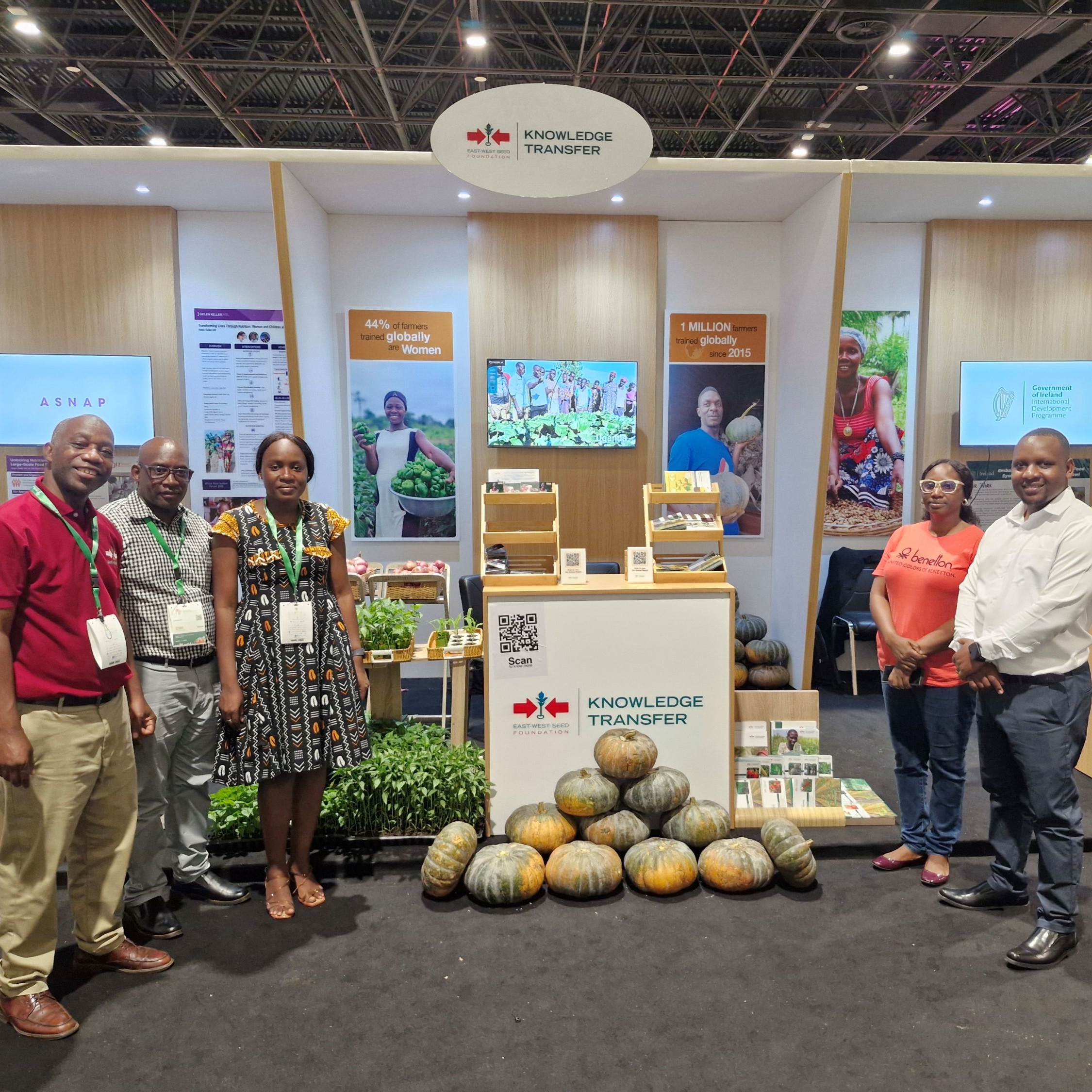 East-West Seed Knowledge Transfer Foundation delegation in front of their booth.