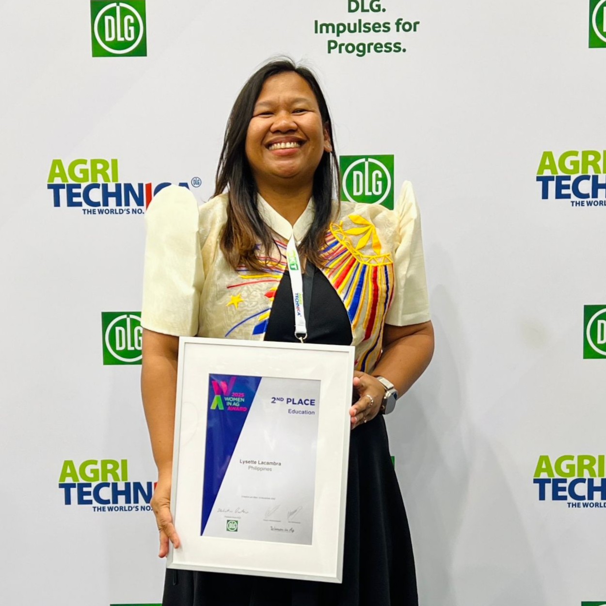 Lysette Lacambra holds her 2025 Women in Ag Award at the award ceremony.