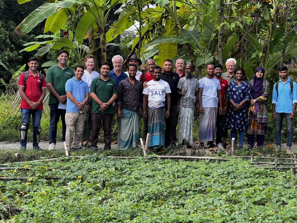 The 4-member EWS-KT Board of Trustees poses with staff and farmers.