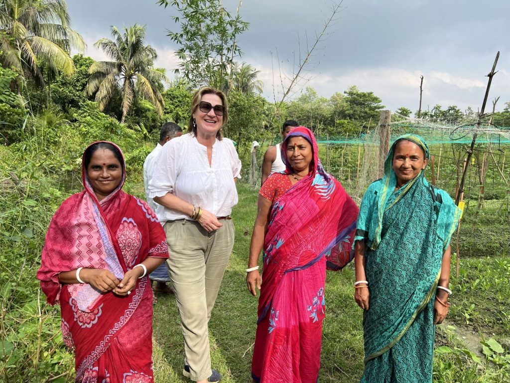 Board member Brigit van Dijk – van de Reijt with three women farmers.