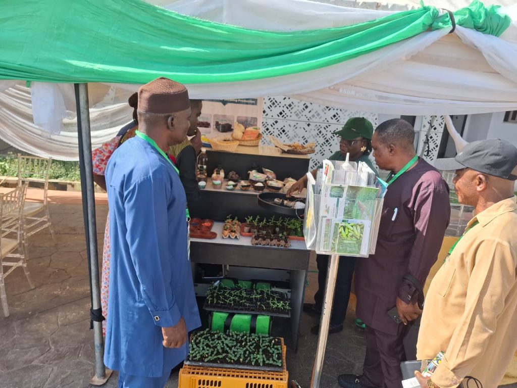 Visitors to our booth at the 47th National Council on Agriculture and Food Security (NCAFS), with seedlings and printed crop guides displayed.
