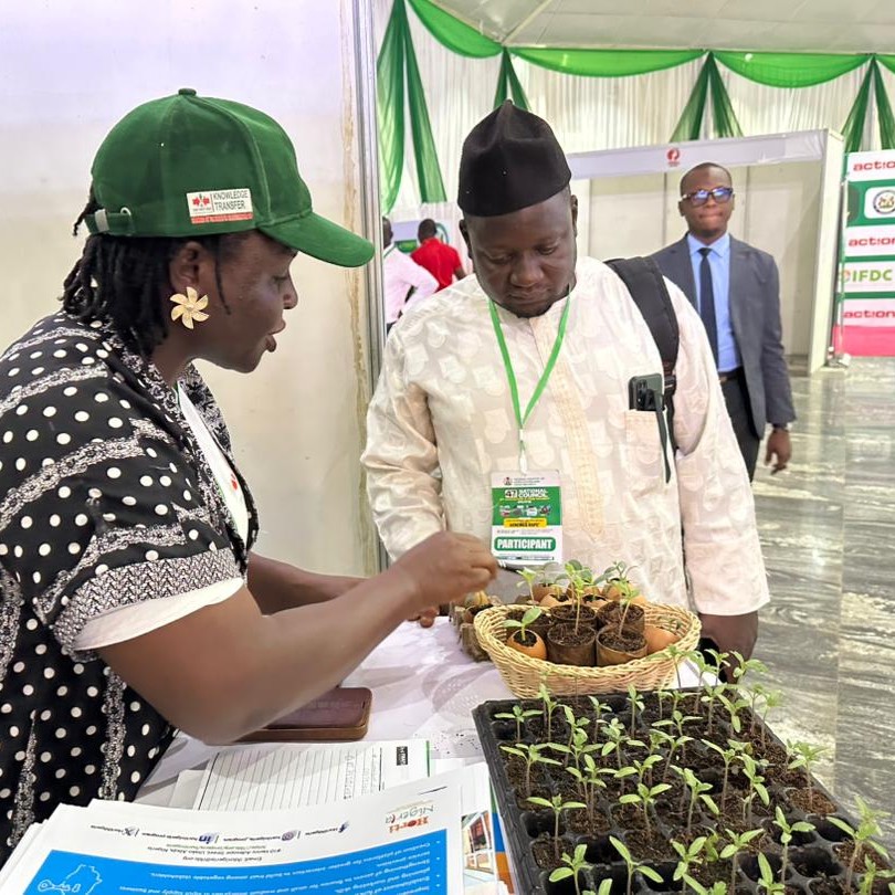 A visitor to our booth at the 47th National Council on Agriculture and Food Security (NCAFS) admires the seedlings on display.