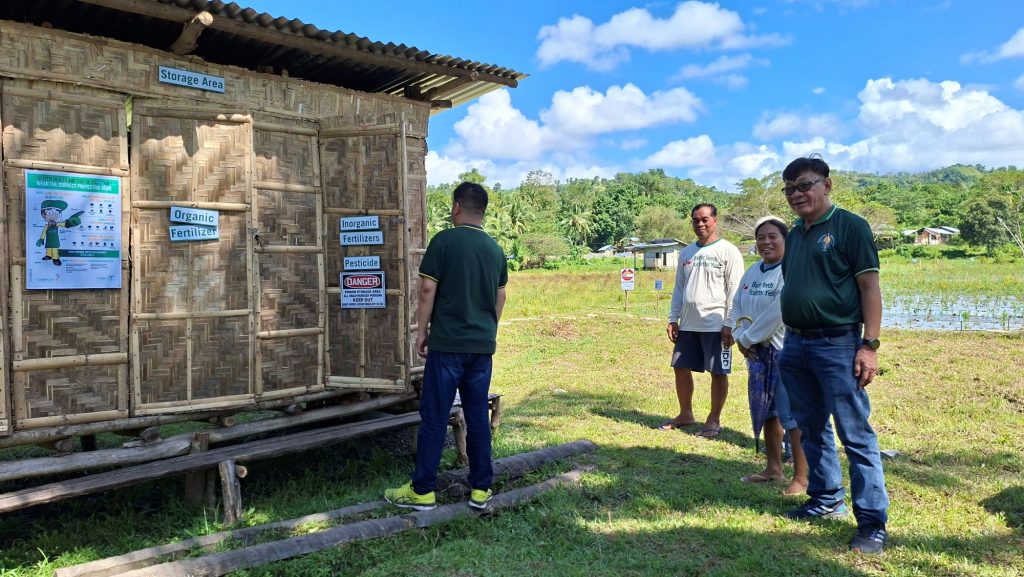 Government inspectors take a look at a farm's storage building during the PhilGAP assessment.