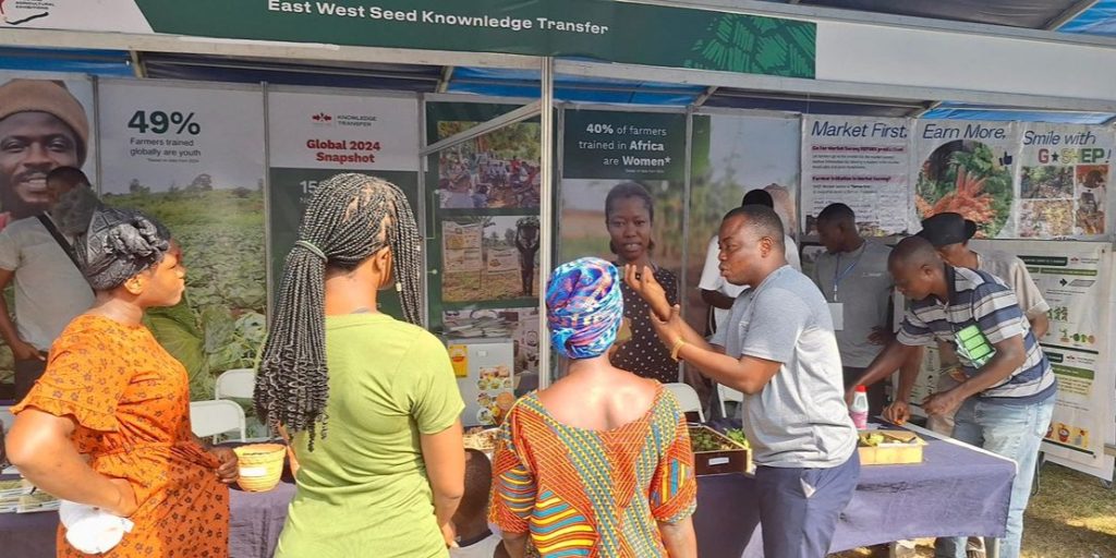 Visitors to the EWS-KT booth at the National Agricultural Fair learn about climate-smart agronomic practices.