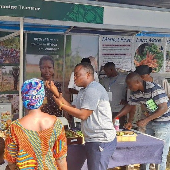 Visitors to the EWS-KT booth at the National Agricultural Fair learn about climate-smart agronomic practices.