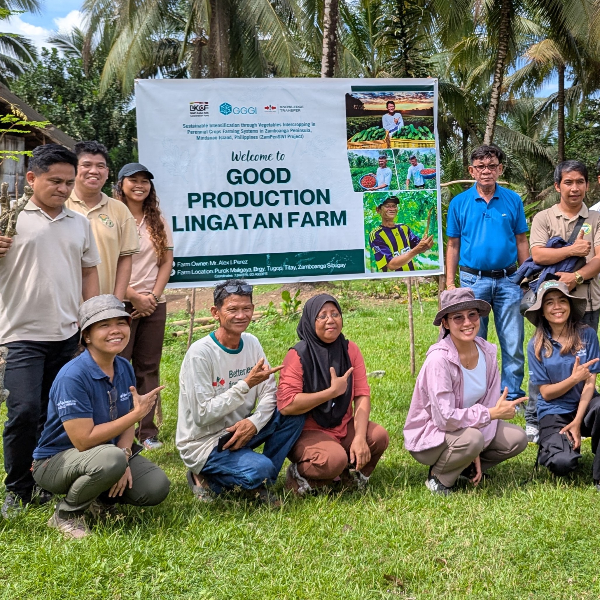People around a banner for Good Production Lingatan Farm.