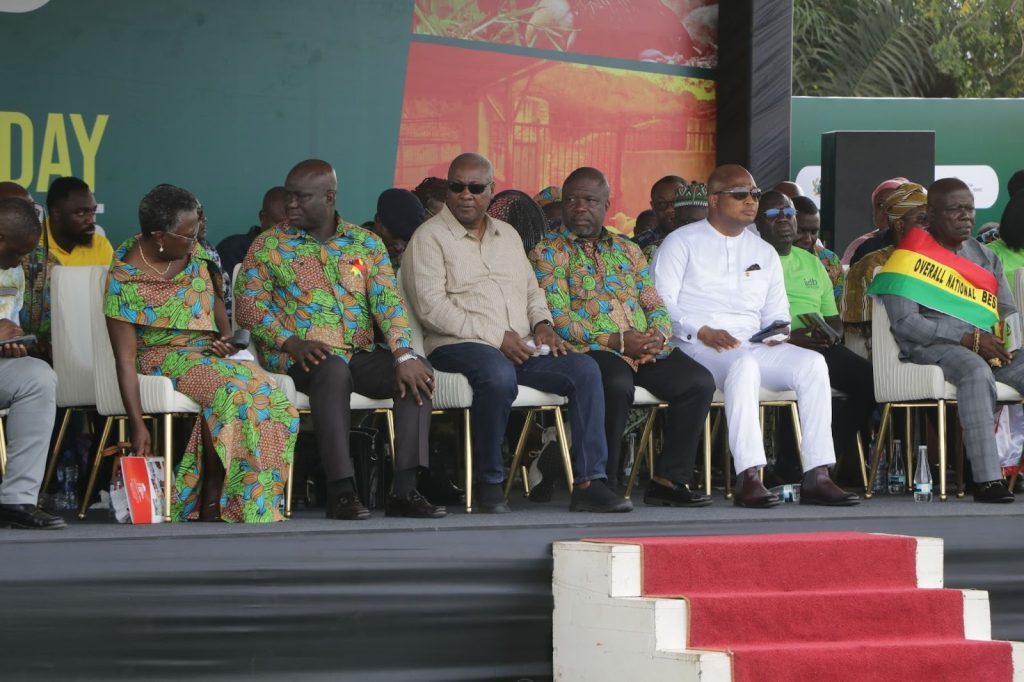 The Ghanaian president and other country leaders sit on the stage at the National Farmers' Day celebration.