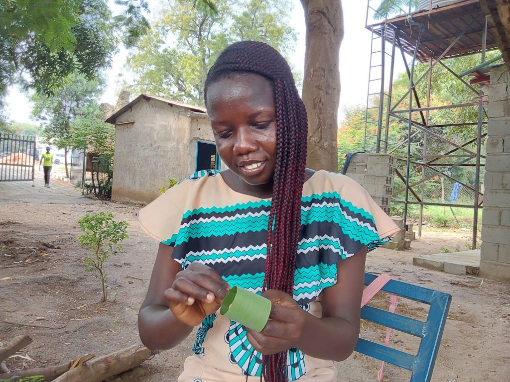 South Sudanese student and farmer Gloria Hibba Juma forms a sustainable pot from a leaf strip.