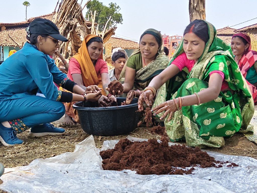 Guided by a staff member from East-West Seed Knowledge Transfer Foundation, smallholder female farmers in Chhattisgarh, India, prepare the medium for growing hot pepper seedlings.