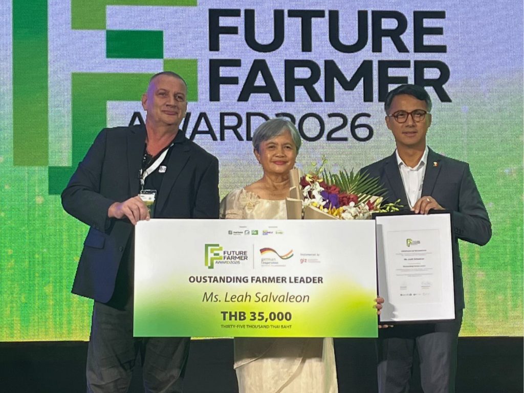 Farmer Leah Salvaleon with two men displaying her Future Farmer Award.