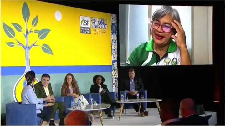 Filipino farmer Leah Salvaleon appears on a large video screen as part of a panel discussion at the International Seed Federation 2026 congress.